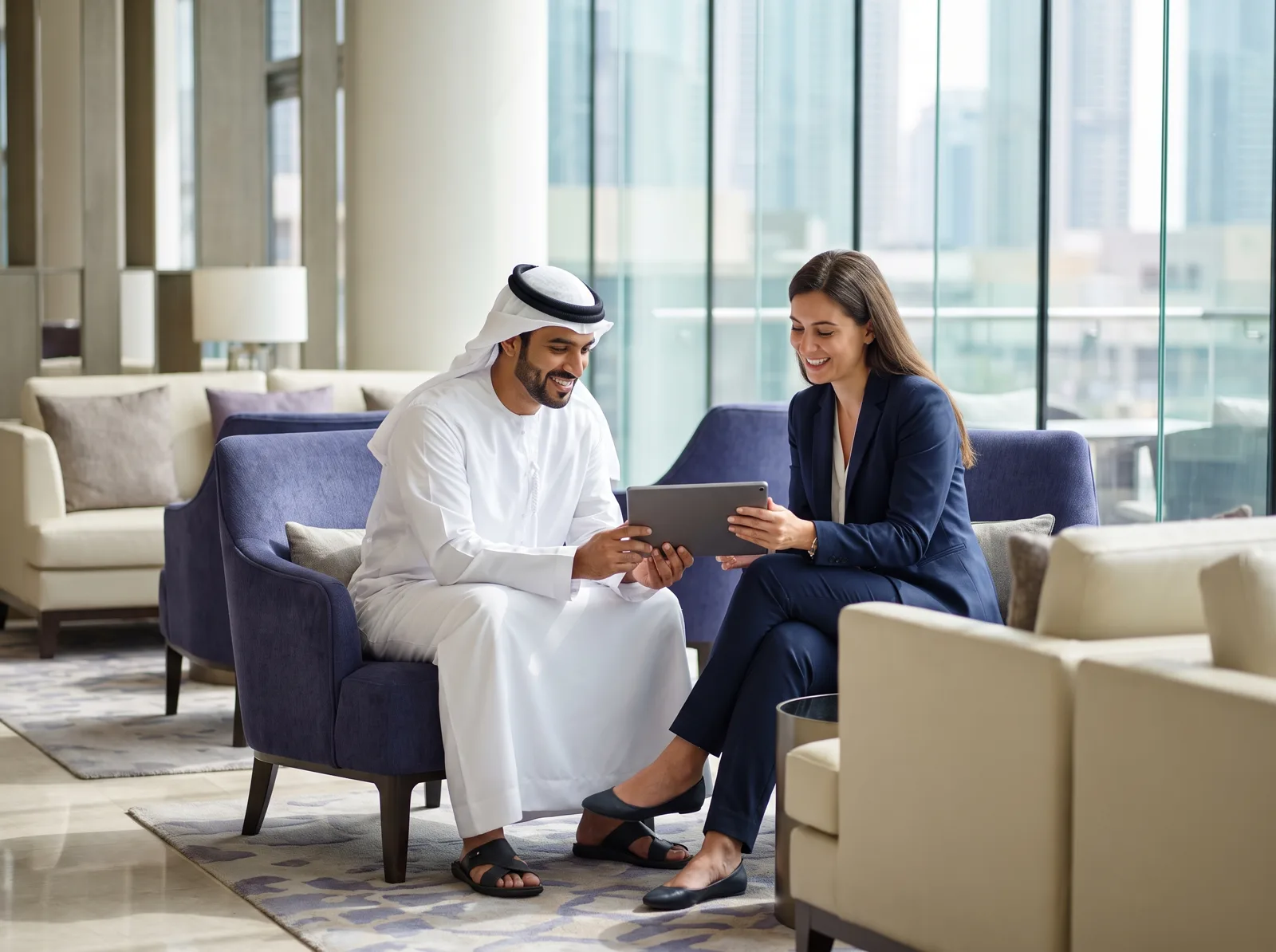 Two partners reviewing HeyServo together in a Dubai hotel lobby